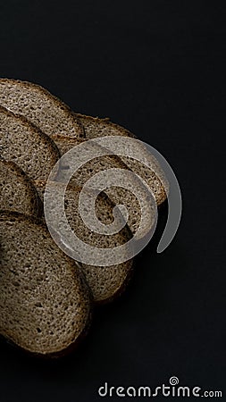 sliced â€‹â€‹rye bread on black background Stock Photo
